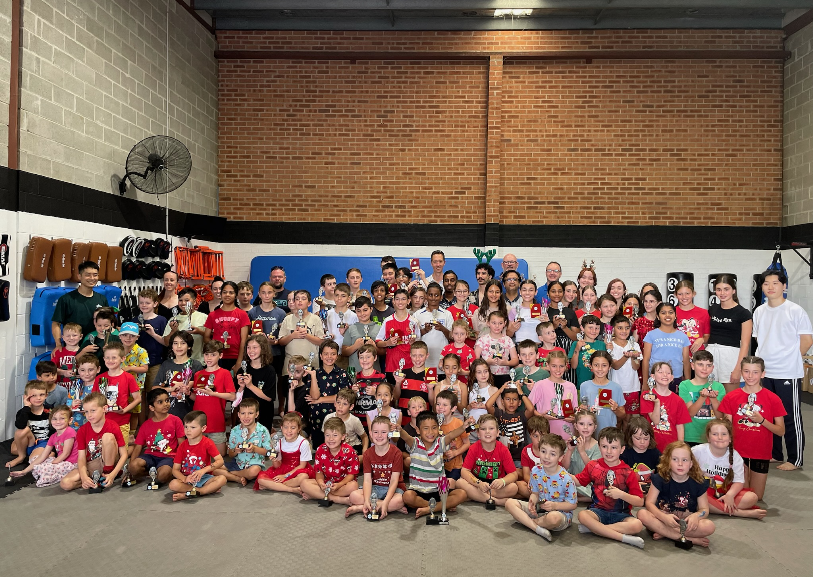 KYU Taekwondo community celebrating achievements with flags and students of all ages